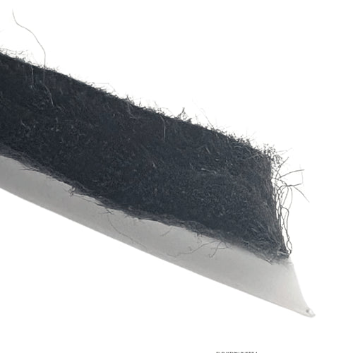 Black strip of filter with fibers on a white background